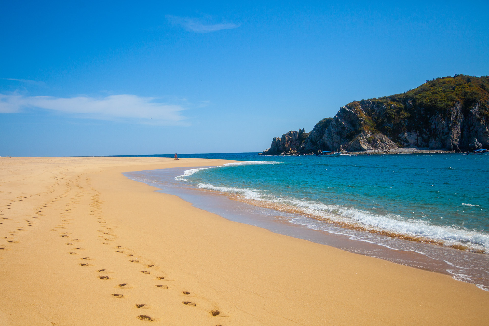 Sandy beach and cliff in Huatulco Bays